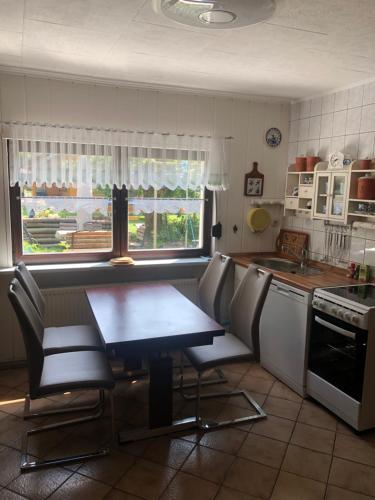 a kitchen with a table and chairs in a kitchen at Haus am Finowkanal in Eberswalde