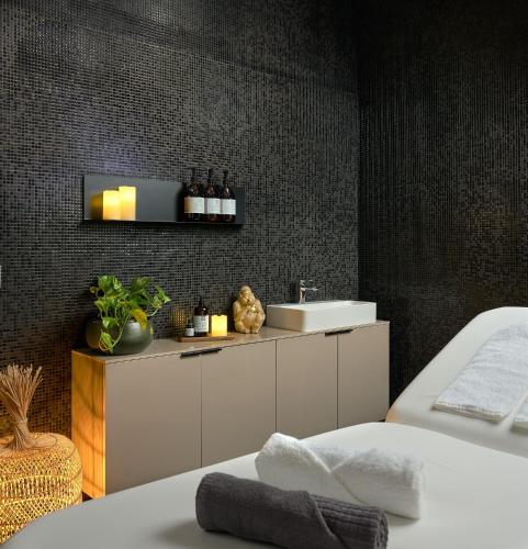 a bathroom with a sink and a counter with a sink at Verno House Budapest, Vignette Collection by IHG in Budapest