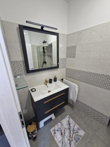 a bathroom with a sink and a mirror at Villa Galleria in Sukošan