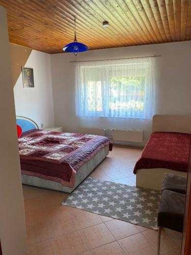 una camera con un grande letto e una finestra di House Damado Deluxe a Öttevény