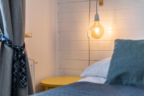 a bedroom with a bed with a lamp and a table at TatryTop Alpejski SPA in Kościelisko