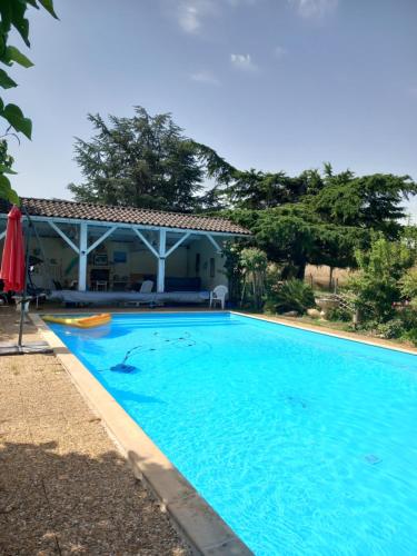 a swimming pool in front of a house at Chez Pepette et Serge in Montdragon