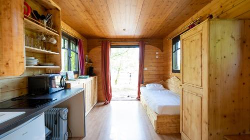 a small kitchen with a bed in a tiny house at Le Village de la Champagne - Slowmoov in Bar-sur-Aube