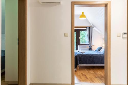 a door leading into a bedroom with a bed at TatryTop Alpejski SPA in Kościelisko