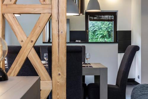 a dining room with a table and chairs at TatryTop Alpejski SPA in Kościelisko