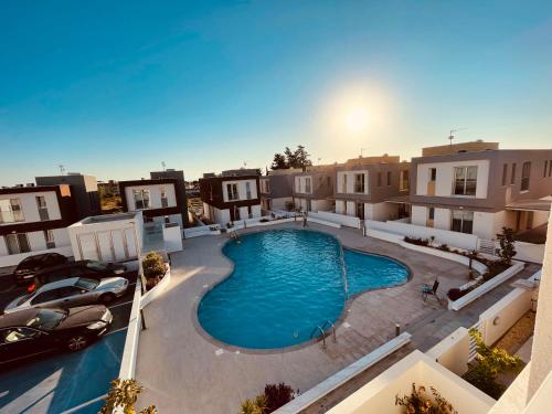 an overhead view of a swimming pool in a building at City Center Cozy Apt in Paphos City