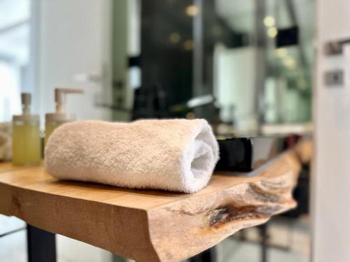a towel sitting on a wooden counter in a bathroom at LeBlanc Luxurious Beachfront Villa by Goutos Luxury Living in Ermioni