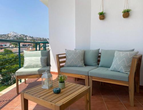 a balcony with two couches and a coffee table at Ítaca Apartments Peñiscola - Cerromar in Peniscola