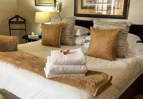 a bedroom with a bed with towels on it at Brighton Lodge - #Solar Energy #No Loadshedding in Port Elizabeth
