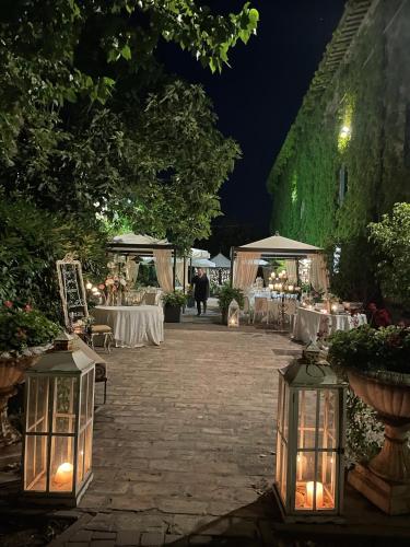 a patio with tables and chairs at night at Azienda Agricola Palazzo Manzoni in San Zaccaria