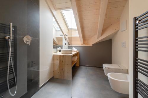 a bathroom with a sink and a toilet at BB Attic Suite in Cavalese