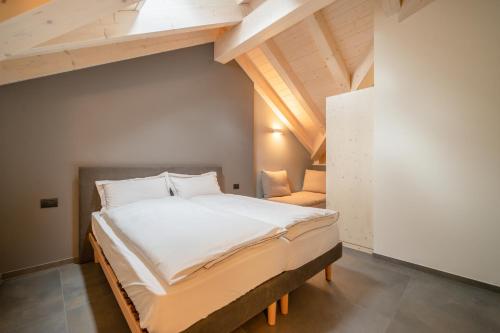 a bedroom with a large bed in a loft at BB Attic Suite in Cavalese