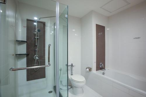 a bathroom with a toilet and a glass shower at Kantary Hotel Ayutthaya in Phra Nakhon Si Ayutthaya