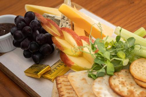 a tray of cheese and fruit and crackers and grapes at The Beaches Hotel and Spa in Prestatyn