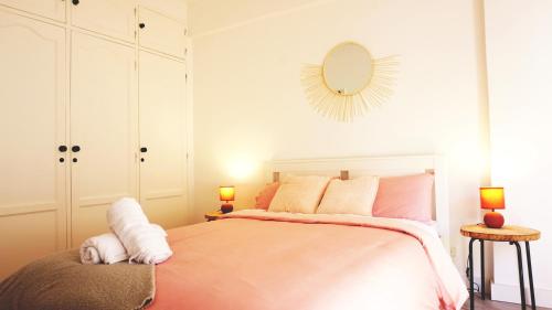 a bedroom with a bed with a mirror on the wall at SINTRA STAY - Massamá Guesthouse in Queluz