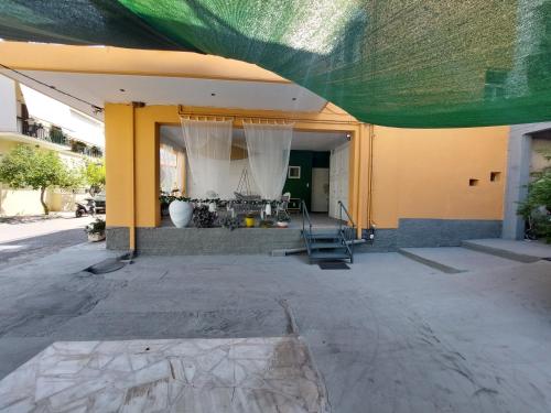 a building with a green covering over the front of it at Oranje Guesthouse in Itea