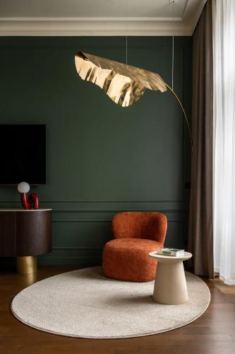 a living room with a chair and a table at Verno House Budapest, Vignette Collection by IHG in Budapest