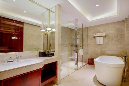 a bathroom with a toilet and a sink and a shower at Zhongshan Phoenix By Funyard in Zhongshan