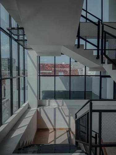 a staircase in a building with glass windows at AJ BOUTIQUE HOTEL in Yogyakarta