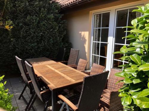 a wooden table and chairs on a patio at Landferienhaus Sonnenblume in Hagen