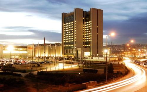 a city at night with traffic and a tall building at CPAnkara Hotel in Ankara