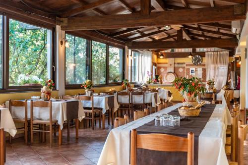 a restaurant with tables and chairs and windows at Agriturismo Sa Tanca Noa in Tergu