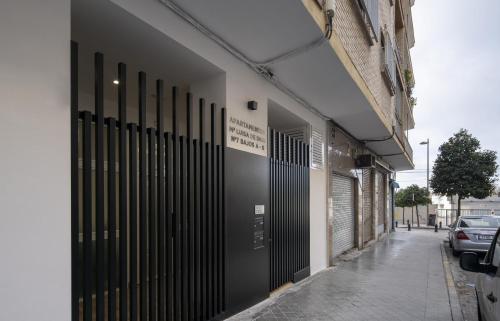 a building with black doors on the side of a street at Apartamentos Mª Luisa de Dios Nº7 in Granada