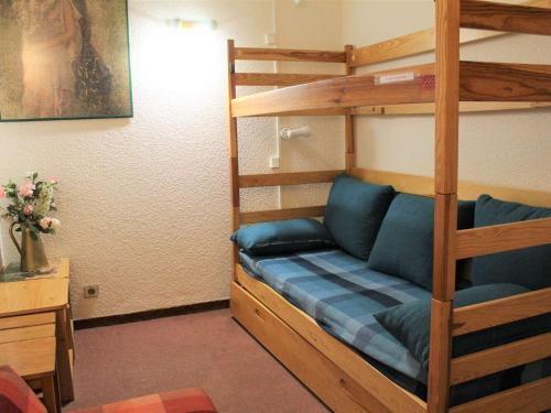 a bedroom with a bunk bed with blue pillows at Appartement Vars, 1 pièce, 4 personnes - FR-1-330B-121 in Vars