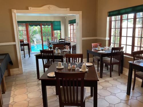 a restaurant with tables and chairs and a pool at Brighton Lodge - #Solar Energy #No Loadshedding in Port Elizabeth