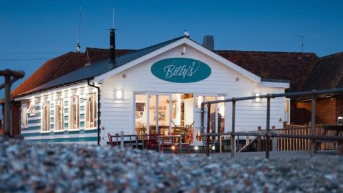 a restaurant with a sign on the side of a building at East Walls Apartment in Chichester