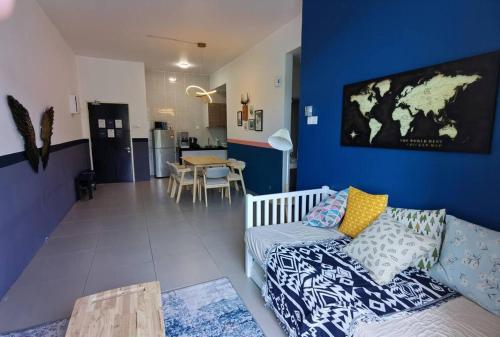 a living room with a couch and a blue wall at WingsNest Cameron Town Night Market High Speed Wi-Fi in Tanah Rata