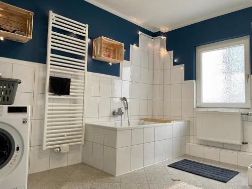 a bathroom with a sink and a washing machine at Bötchen - modern, zentral, für TreppensteigerInnen in Bremerhaven