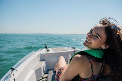 a young woman sitting on a boat in the ocean at Rooms at Haslar Marina in Gosport