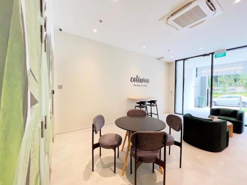 a conference room with a table and chairs and a couch at Coliwoo 298 River Valley - CoLiving in Singapore