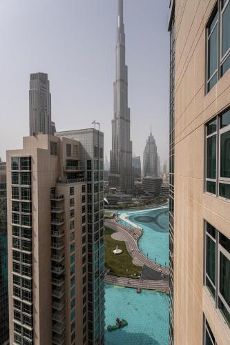 a view of a city with tall buildings at INA Homes-Tower 5 Perfect Burj Khalifa and Fountain Views in Dubai