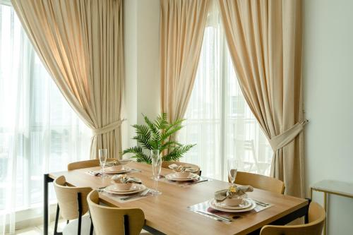 a dining room with a wooden table and chairs at INA Homes-Tower 5 Perfect Burj Khalifa and Fountain Views in Dubai