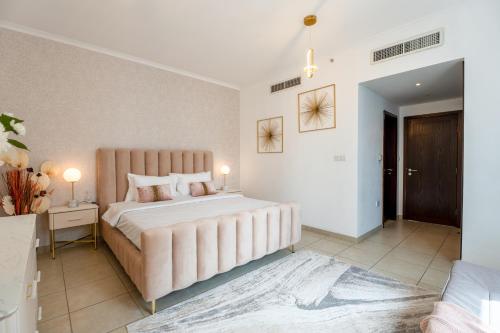 a large bedroom with a large bed and a table at INA Homes-Tower 5 Perfect Burj Khalifa and Fountain Views in Dubai