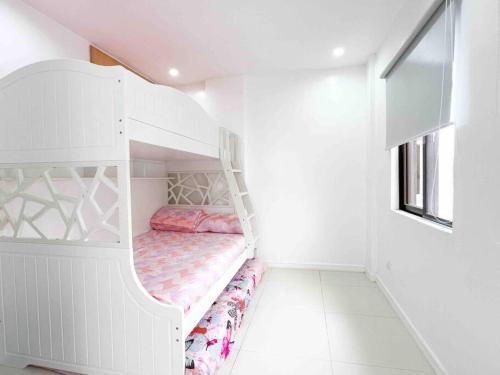 a white bunk bed in a white room at Elegantly Presented Spacious 3 Bedroom House in San Isidro