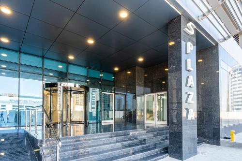 a lobby of a building with a sign that says hotel at S Plaza Suites Hotel in Seef
