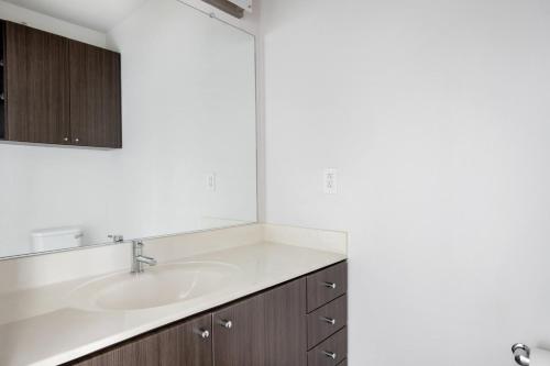 a bathroom with a sink and a mirror at East Cambridge 2br w gym wd nr green line BOS-876 in Boston