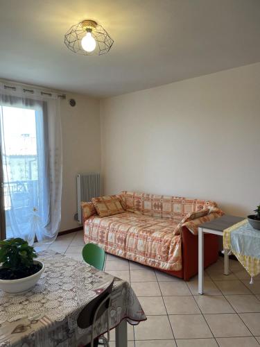 a living room with a couch and a table at Appartamento Diana in Oderzo