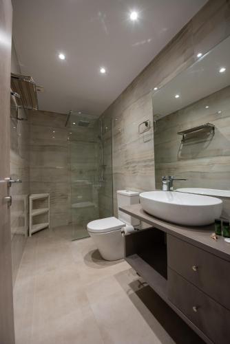 a bathroom with a sink and a toilet and a shower at Casa de Lapel Kallithea in Kallithea Halkidikis