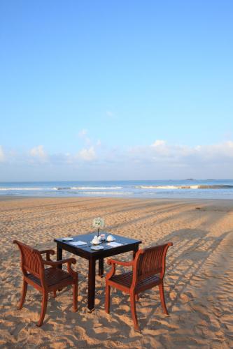 a table and two chairs on the beach at Thaala Bentota in Bentota