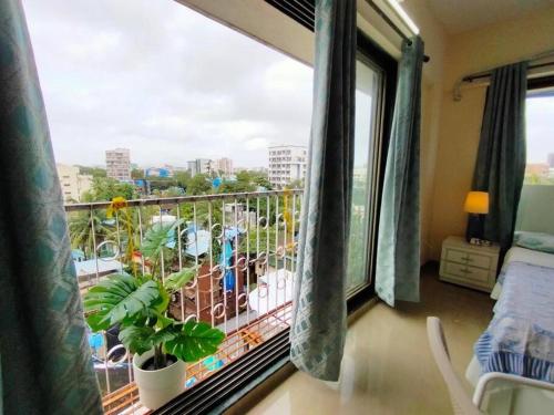 a room with a balcony with a large window at 5 - Studio Velankanni Heights, Behaind Nanavati Hospital, Vile Parle by Connekt Homes in Mumbai