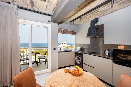 a kitchen with a table with a bowl of fruit on it at Salini Suites in Żebbuġ