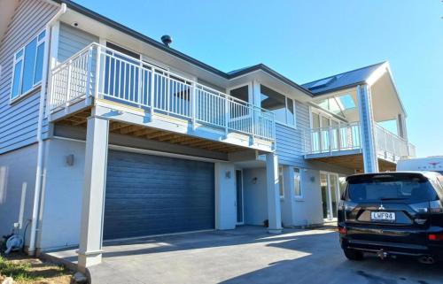 a van parked in front of a house at Stylish Matua Apartment in Tauranga