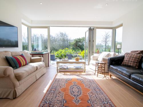 a living room with a couch and a tv at Pass the Keys Peaceful Countryside Residence in Pershore