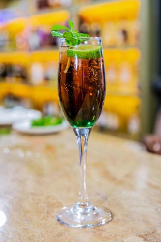 a drink in a glass with a lime in it at Best Western Dodoma City Hotel in Dodoma
