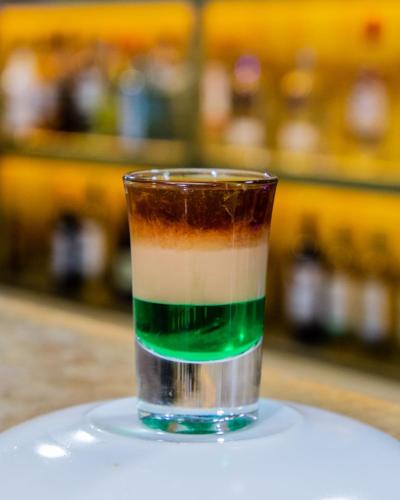 a drink in a glass sitting on a table at Best Western Dodoma City Hotel in Dodoma