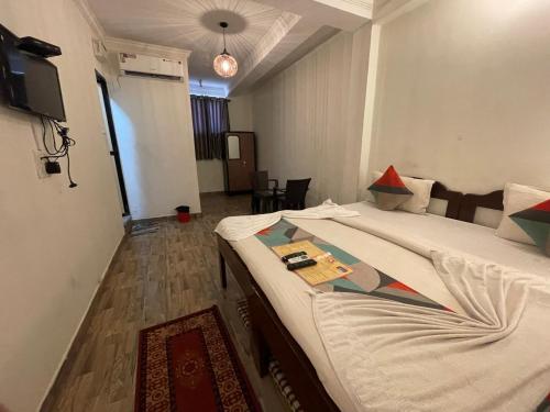 a hotel room with a bed and a tv at Baga View Inn in Baga
